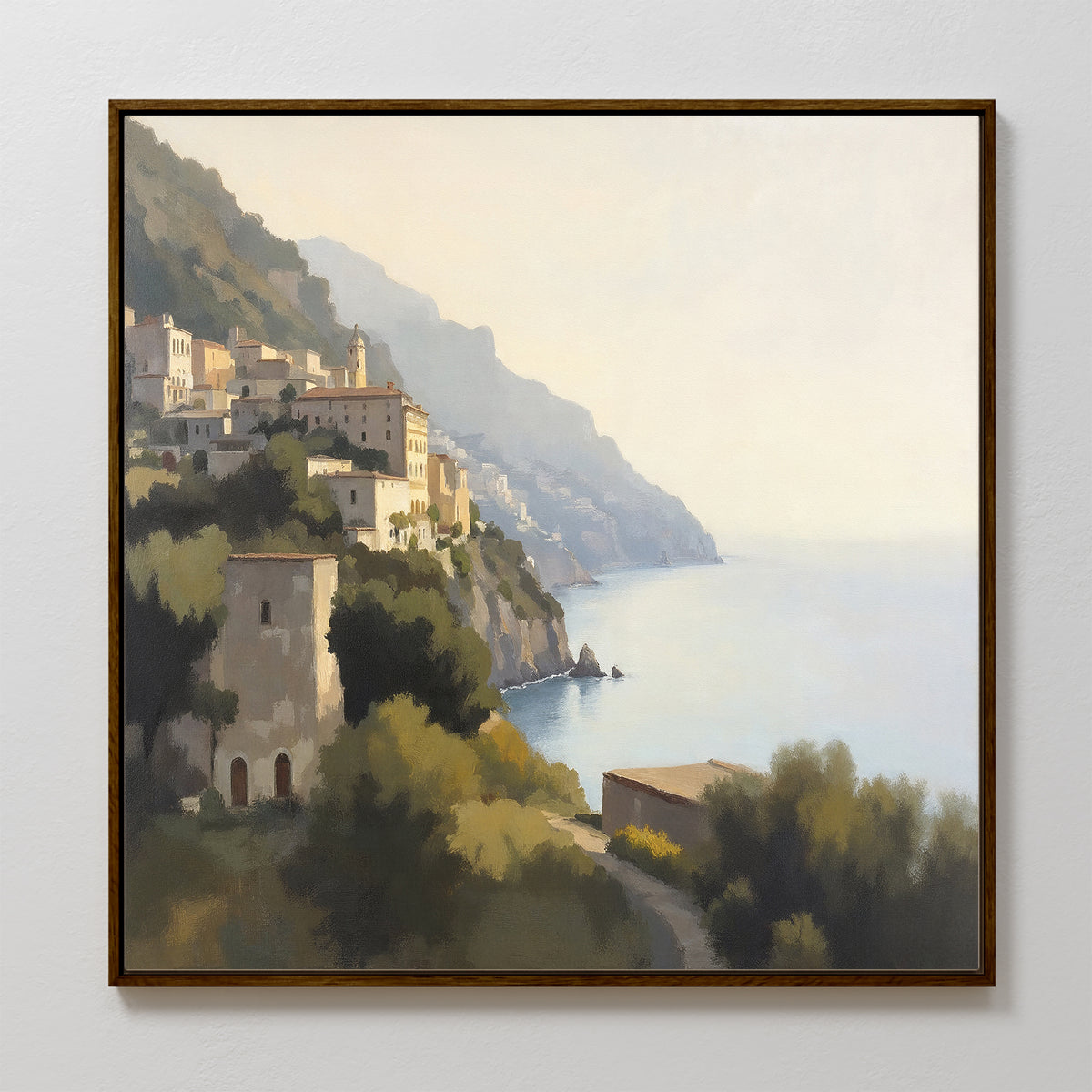 The Italian Reverie Canvas Art - Square features a framed Mediterranean coastal village on a sunlit hillside above the calm sea, with soft shadows and lush greenery—an elegant choice for home decor.