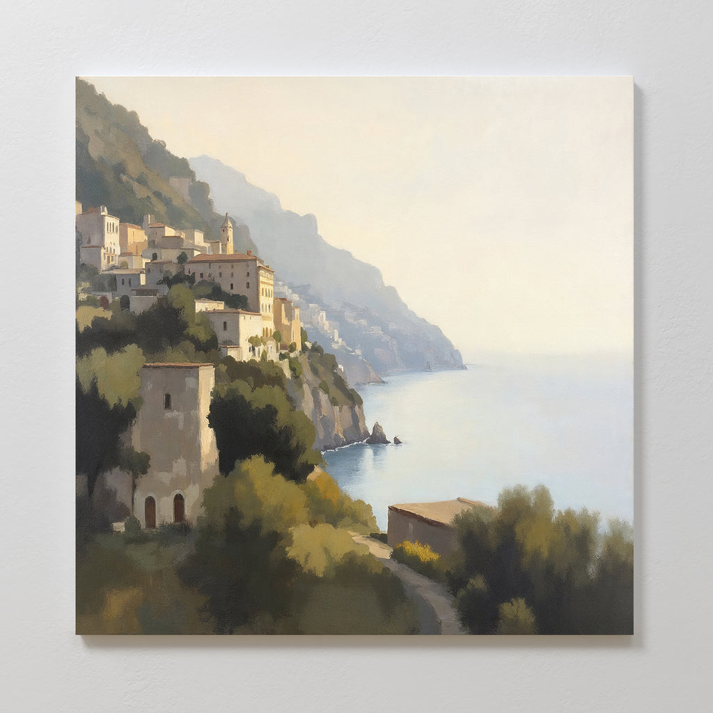 Italian Reverie Canvas Art - Square depicts a coastal village on a hillside above a calm sea, sunlit buildings and greenery, and misty distant mountains—perfect as Mediterranean or coastal wall art.