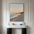 The Coastal Reverie Canvas Art - Vertical hangs on a light paneled wall above a modern console table with candles and minimalist vases, bringing serene coastal style to your home decor.
