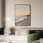 A modern living room features the Coastal Reverie Canvas Art - Vertical above a gray stone bench. A green chair, a vase with dried branches, and light candles complete this cozy, minimalist look—perfect for tranquil home decor.