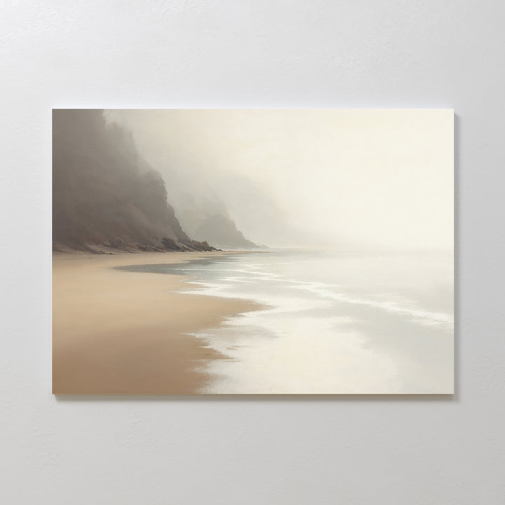 Coastal Silence Canvas Art - Horizontal features calm waves, misty cliffs, and soft beige sand under a cloudy sky—ideal for adding muted coastal decor and a peaceful vibe to any space.