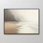 The Coastal Silence Canvas Art - Horizontal features a misty beach scene with gentle waves, sandy shores, and rocky cliffs in soft beige, brown, and gray—ideal for muted coastal décor on a light-colored wall.