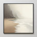 The Coastal Silence Canvas Art - Square features a serene beach with gentle waves, sandy shores, and misty cliffs fading into the background, all in a natural palette for a calm, minimalistic look.