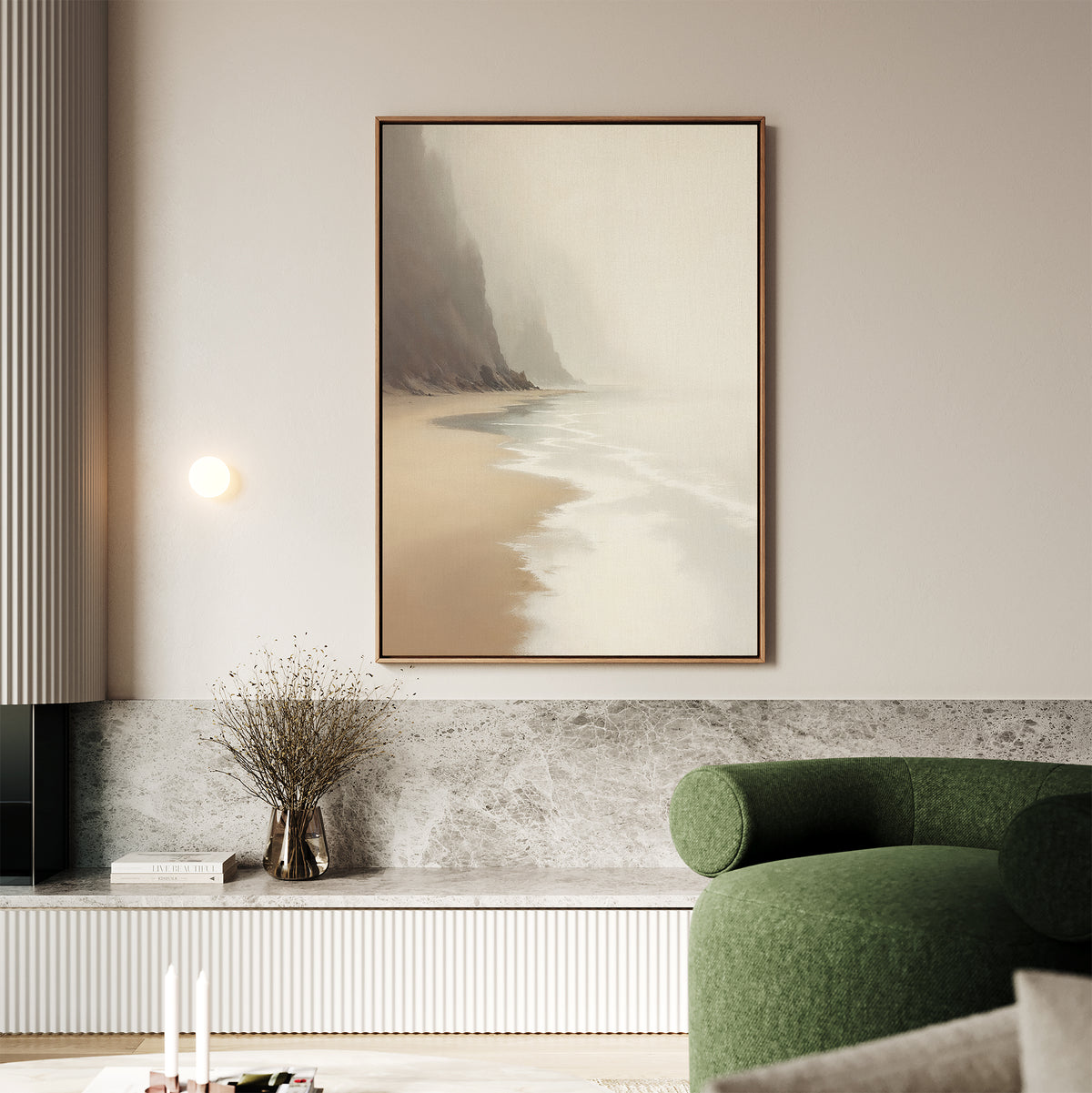 A modern living room with a green armchair, marble accent wall, vase of dried flowers, minimal wall sconce, and the Coastal Silence Canvas Art - Vertical—a large misty beach scene—hanging above.