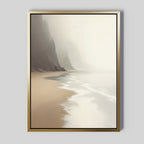 The Coastal Silence Canvas Art - Vertical features a framed print of a misty coastline with gentle waves, sandy shore, and hazy cliffs in soft neutral tones.