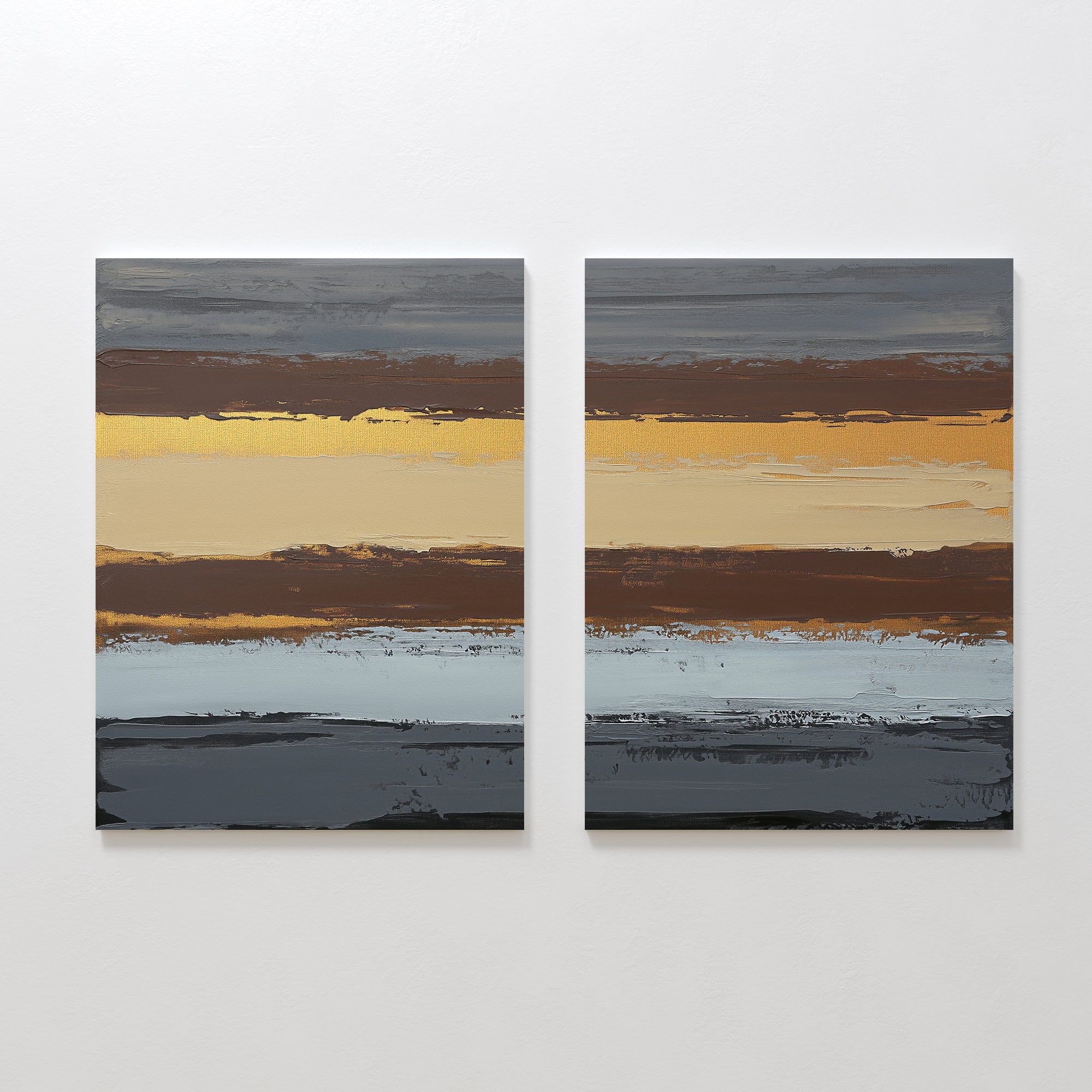 Coastal Strata - Set Of 2: Two square abstract paintings with textured horizontal bands in brown, gold, gray, and blue hues displayed side by side on a white wall for an earthy, sophisticated look inspired by Nordic Park artwork.