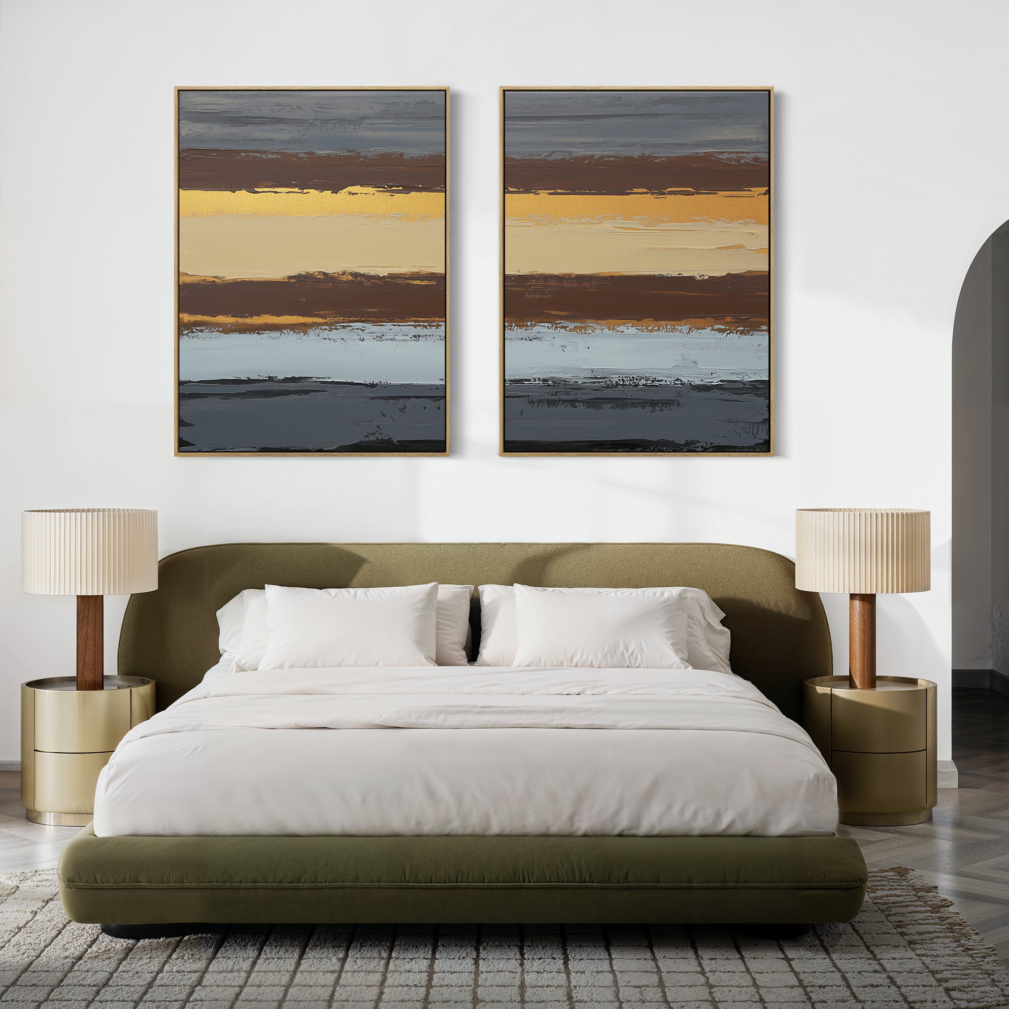 A modern bedroom features an olive green bed with white bedding, two gold nightstands topped with beige lamps, and earthy sophistication highlighted by the Coastal Strata - Set Of 2 artwork above the bed.