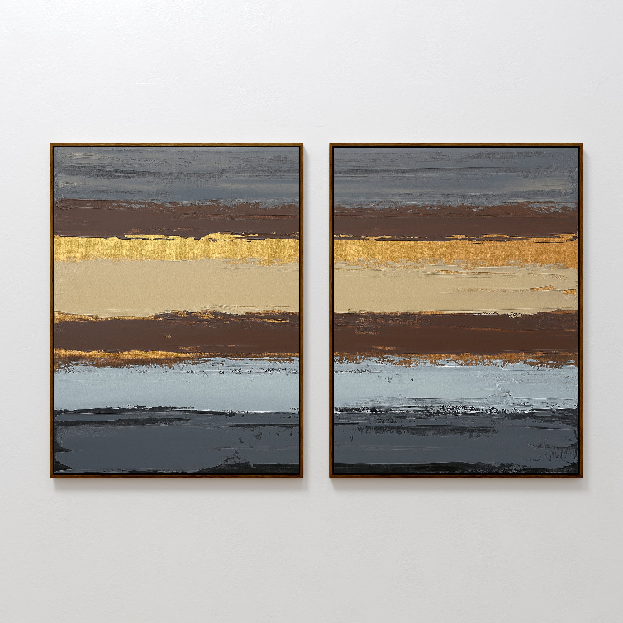 The "Coastal Strata - Set Of 2" features abstract prints with layered stripes in brown, yellow, grey, blue, and gold. Their textured look adds earthy sophistication and refined style to any white wall.