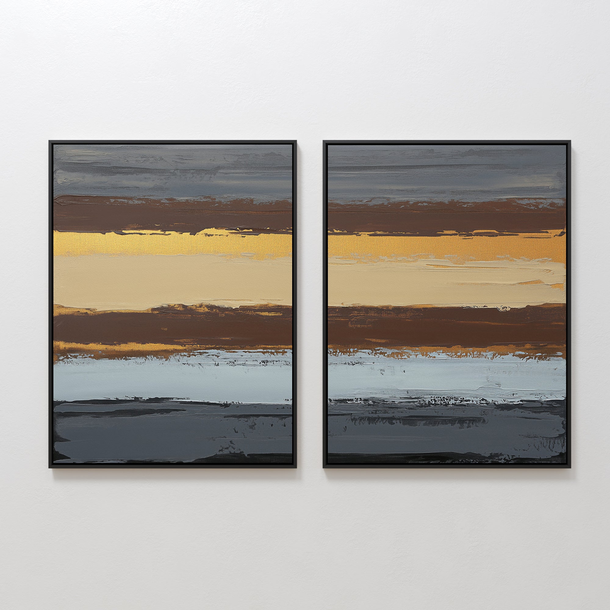 The Coastal Strata - Set Of 2 features framed abstract prints with horizontal brushstrokes in gold, brown, gray, blue, and beige. Displayed side by side, they offer earthy sophistication and a textured look on any white wall.