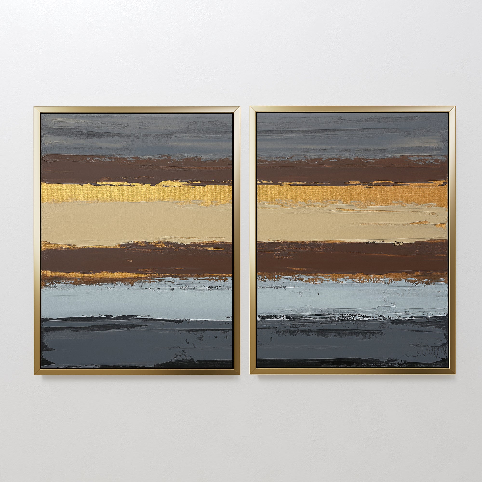 The "Coastal Strata - Set Of 2" features abstract paintings with horizontal stripes in gold, brown, gray, blue, and black. Each piece is gold-framed and displayed side by side for a sophisticated touch.