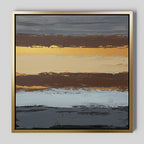 The Coastal Strata Canvas Art - Square features horizontal bands of gold, brown, gray, and black with textured brushstrokes and a metallic sheen, framed in simple gold for an earthy yet contemporary look.