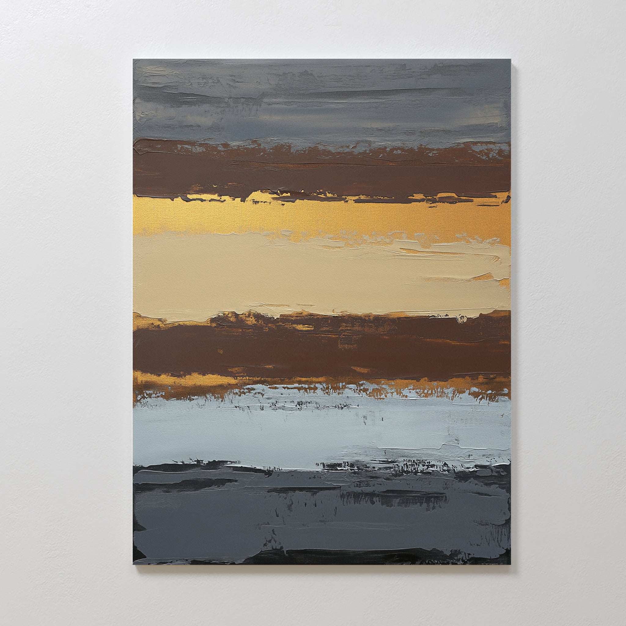 Coastal Strata Canvas Art - Vertical features abstract bands of dark gray, gold, tan, brown, and light blue. This artwork brings earthy sophistication to any space and resembles a layered landscape or sunset against a white wall.