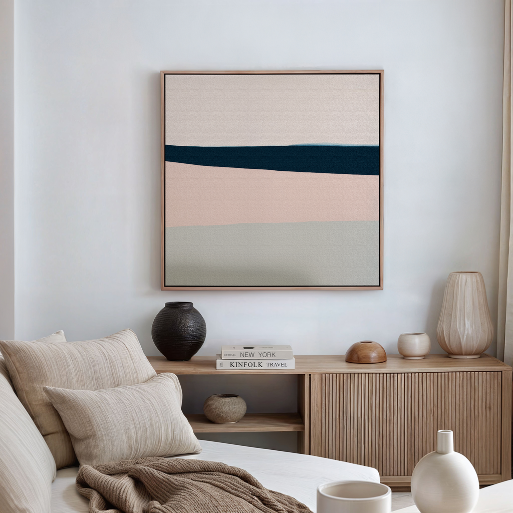 A modern living room with a beige sofa, neutral cushions, wooden sideboard, vases, books, and the My Store Coastal Blend Abstract Canvas Art featuring horizontal color blocks—perfect for contemporary living room inspiration.