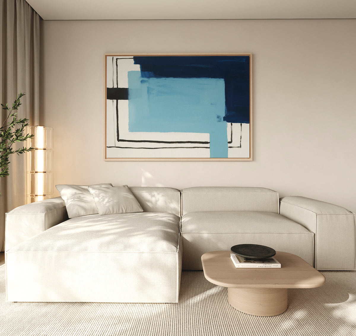 A modern living room features a light beige sectional sofa, a wooden coffee table with books and a black bowl, a tall plant, and the Cobalt Intersection Canvas Art - Horizontal in blue adding flair above the sofa.