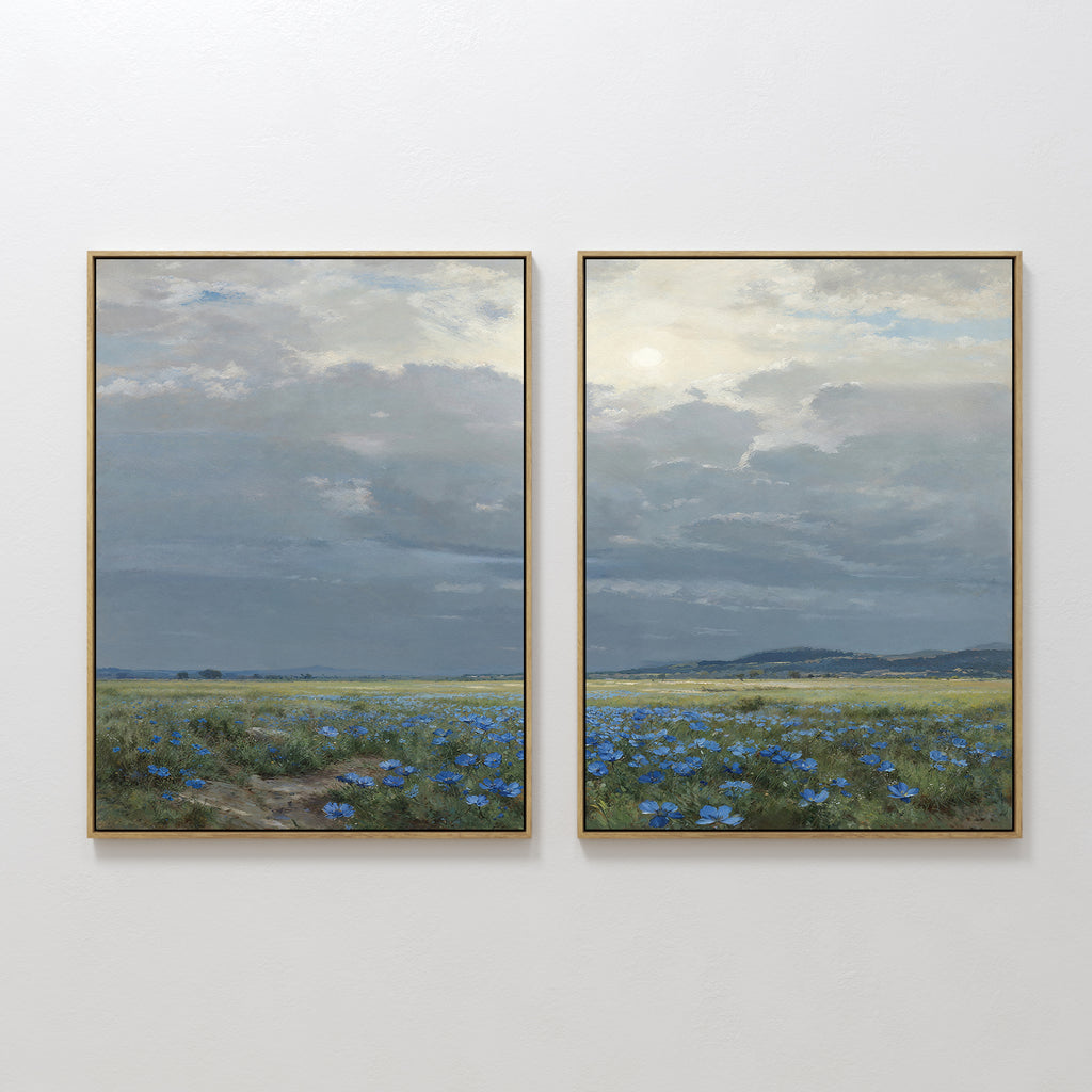 The Cornflower Fields - Set of 2 features framed canvas prints showing tranquil cornflower fields beneath a cloudy sky and distant hills, capturing a calm, expansive landscape with soft light.