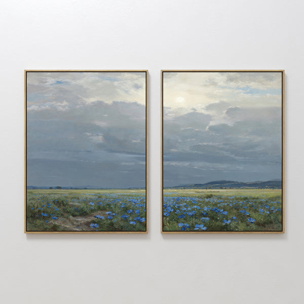 The Cornflower Fields - Set of 2 features framed canvas prints showing tranquil cornflower fields beneath a cloudy sky and distant hills, capturing a calm, expansive landscape with soft light.