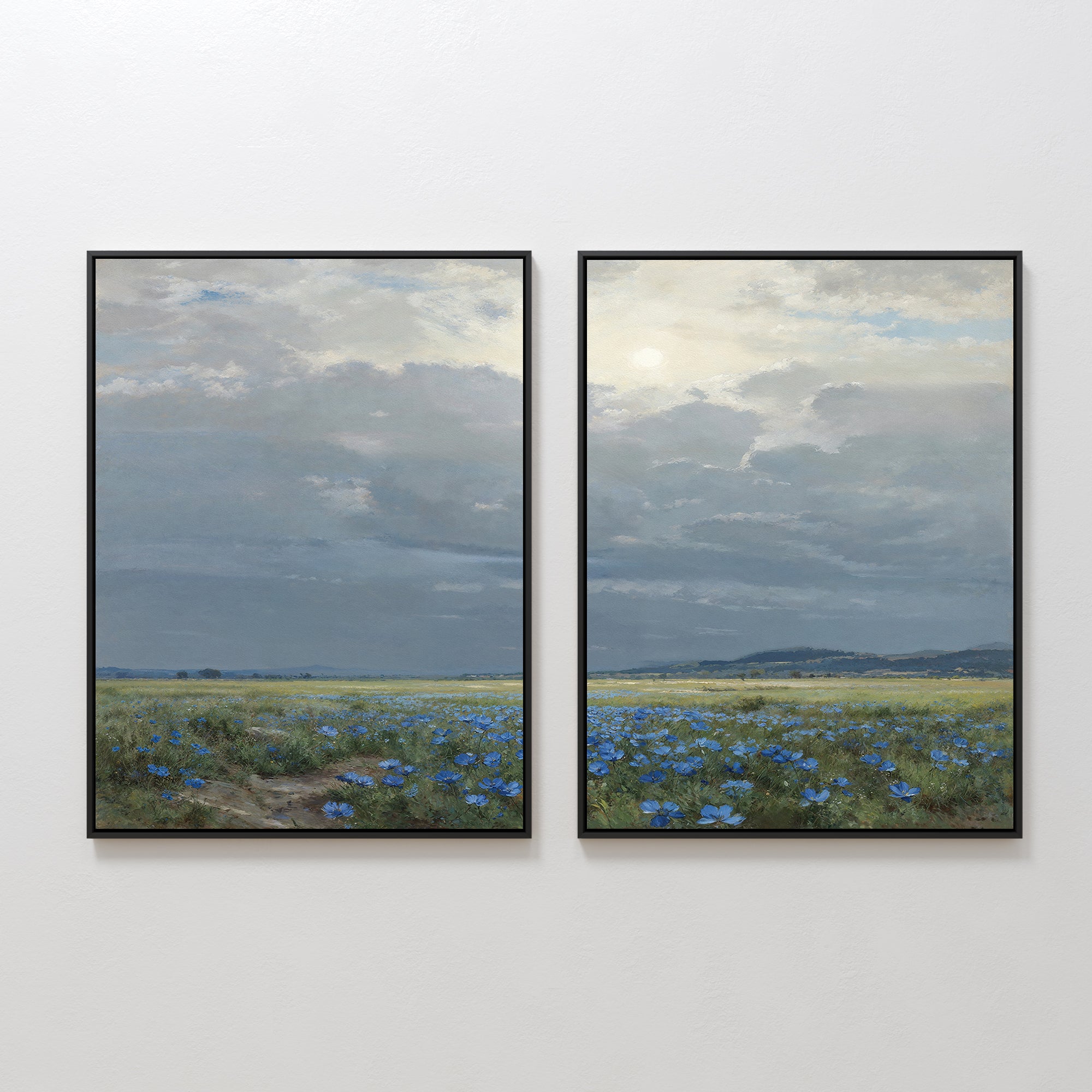 The “Cornflower Fields - Set of 2” includes two framed paintings featuring a continuous pastoral landscape of cornflower fields, distant hills, and a cloudy sky, creating a serene scene when displayed side by side.