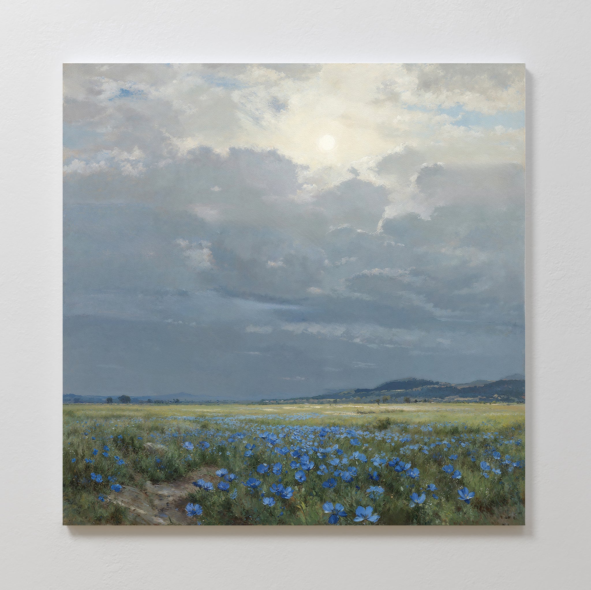 Experience serenity with the Cornflower Fields Canvas Art - Square, featuring a sunlit cloudy sky over cornflower fields and distant hills. This countryside wall art captures nature’s timeless beauty in a peaceful, open scene.