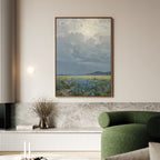 A modern living room featuring a green chair, marble accents, and the Cornflower Fields Canvas Art - Vertical depicting a cloudy sky over cornflower fields, displayed on a light-colored wall.