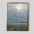 Cornflower Fields Canvas Art - Vertical features a serene pastoral landscape with a cloudy sky, sunlit cornflower fields, distant hills on the horizon, and gentle sunlight filtering through the clouds.