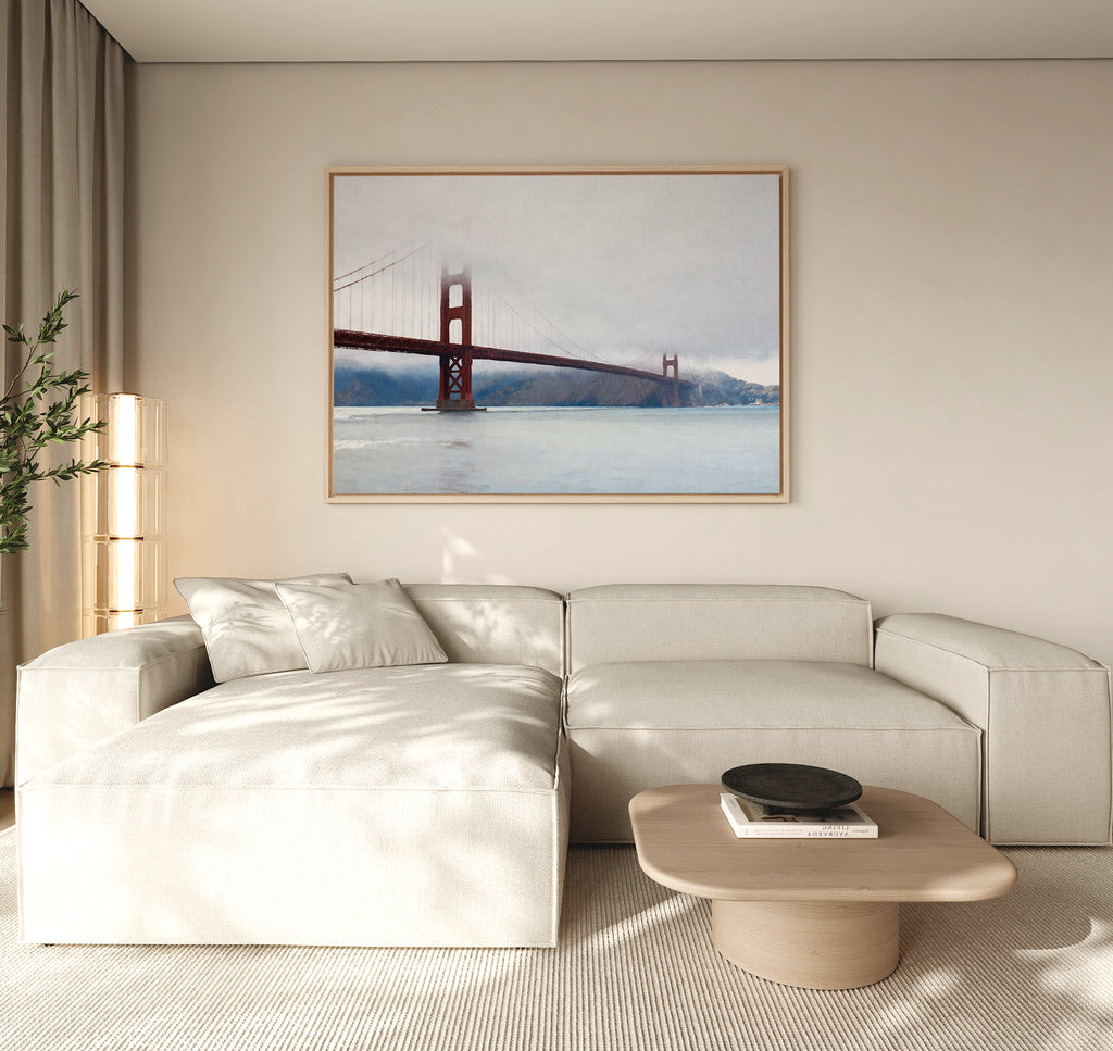 A modern living room with coastal elegance showcases a light beige sectional, a round wooden coffee table, and the Crimson Passage Canvas Art - Horizontal on a neutral wall. A tall lamp and plant in the corner complete the look.