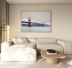 A modern living room with coastal elegance showcases a light beige sectional, a round wooden coffee table, and the Crimson Passage Canvas Art - Horizontal on a neutral wall. A tall lamp and plant in the corner complete the look.