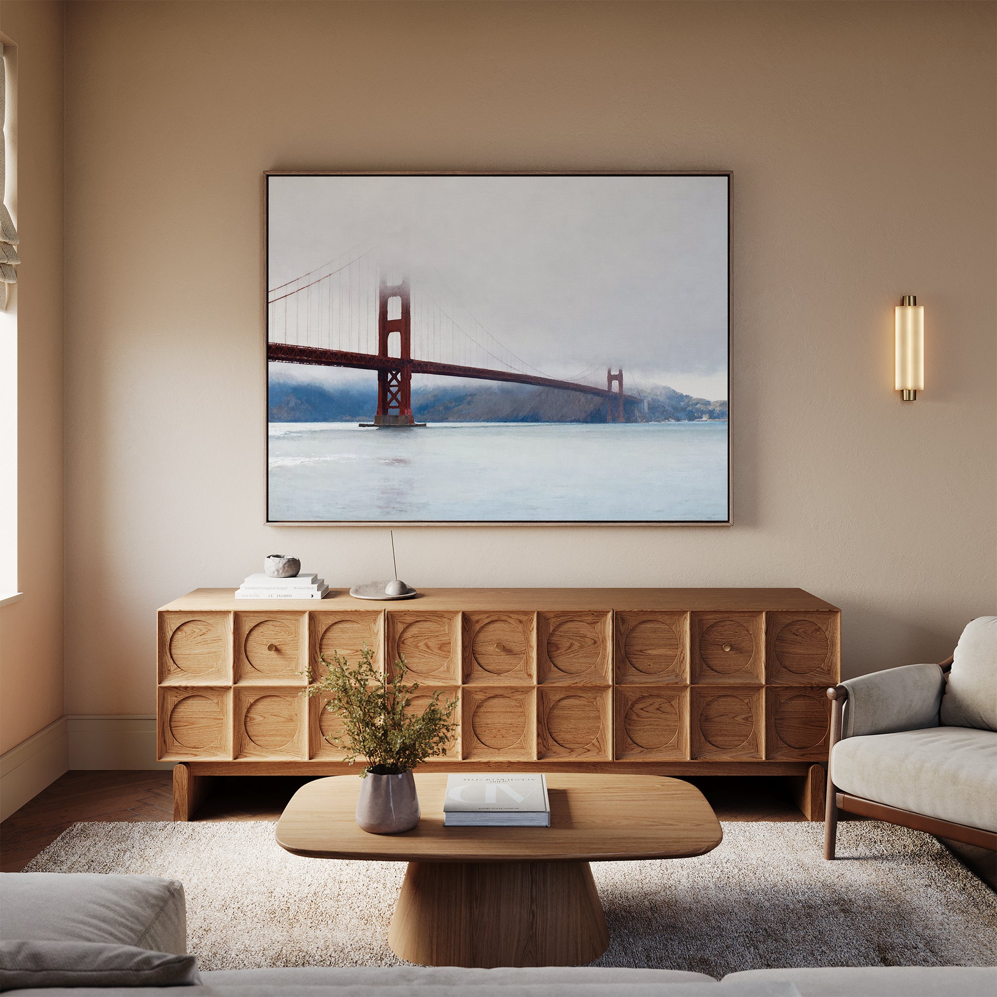 A cozy living room with coastal elegance features a light wood coffee table, cream sofa, and neutral walls. Above the sideboard hangs the Crimson Passage Canvas Art - Horizontal, while a flower vase adds charm to the table.