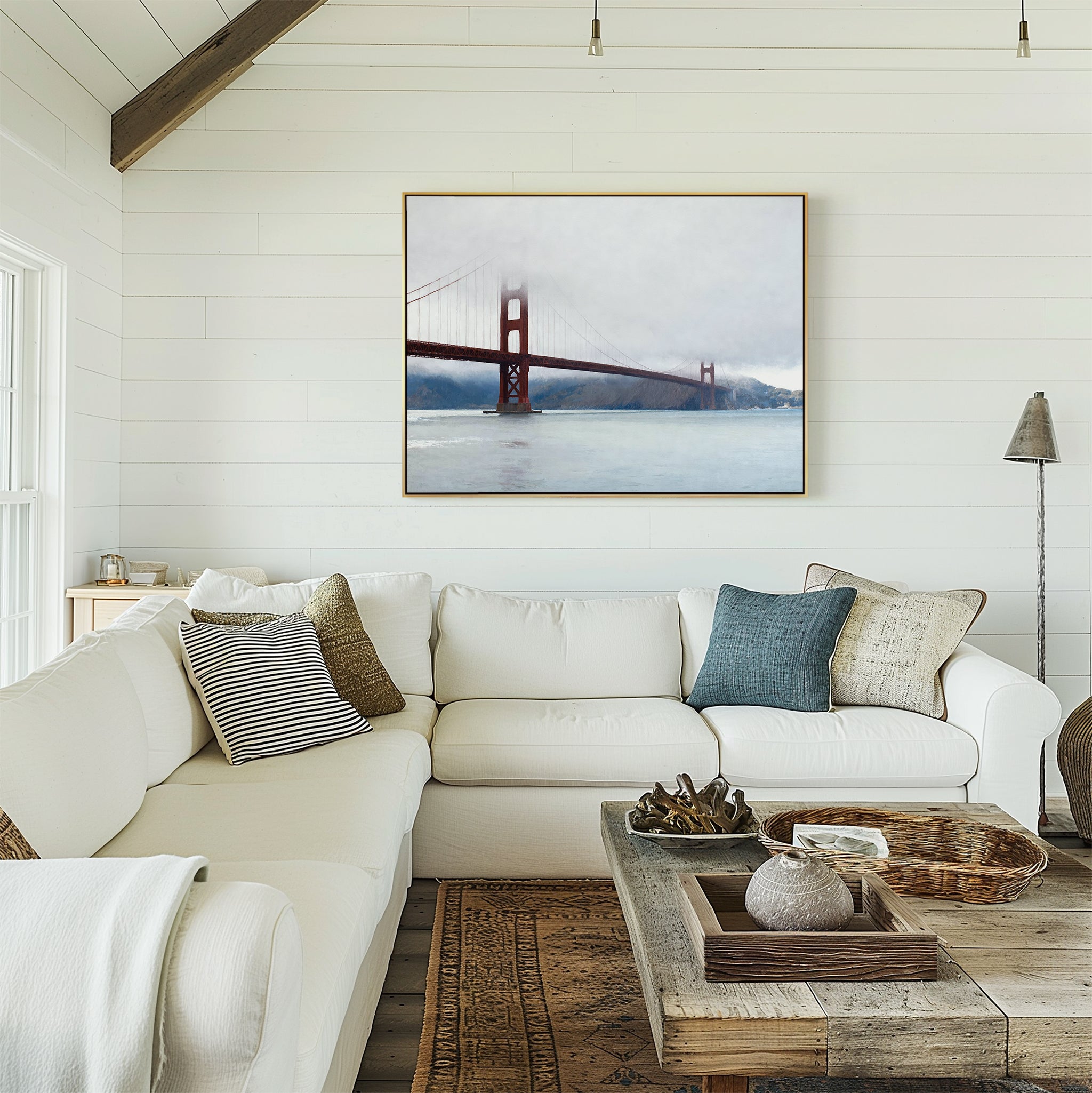 A bright, cozy living room with a white sectional sofa, assorted pillows, a rustic wooden coffee table, and the Crimson Passage Canvas Art - Horizontal on a white shiplap wall exudes coastal elegance.