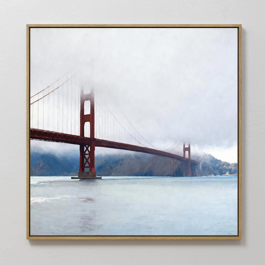 The Crimson Passage Canvas Art - Square captures the coastal elegance of San Francisco’s Golden Gate Bridge, partially veiled by fog, with calm waters and distant hills completing the serene scene.