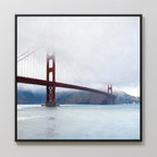 The Crimson Passage Canvas Art - Square depicts the Golden Gate Bridge, partially veiled in fog, extending over serene water with subtle hills behind, capturing the essence of coastal elegance.