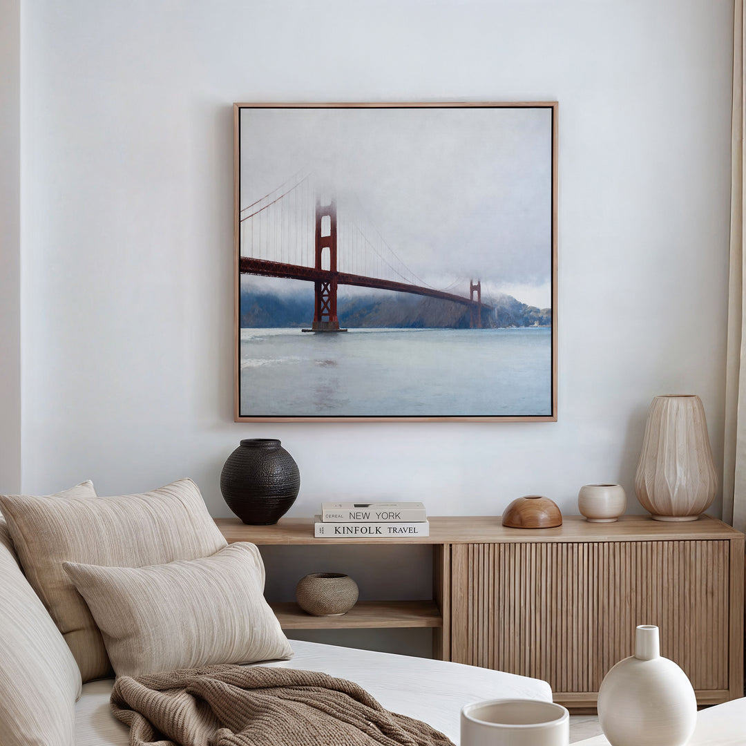 A stylish living room with a beige sofa, neutral cushions, a wooden sideboard, and decorative vases. Above the sideboard on the white wall, the Crimson Passage Canvas Art - Square brings a touch of bold coastal elegance.