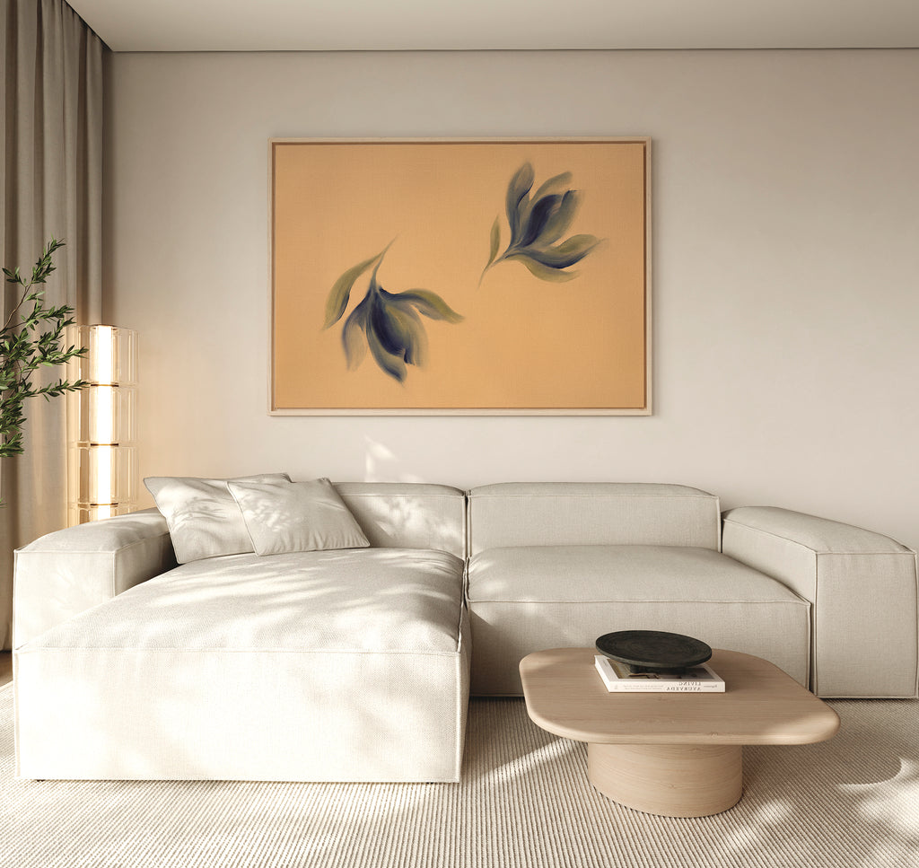 A modern living room with a light beige sectional, low wooden coffee table, tall floor lamp, potted plant, and the Dancing Leaves Canvas Art - Horizontal featuring blue and green leaves adds a Nordic Park-inspired touch to the space.