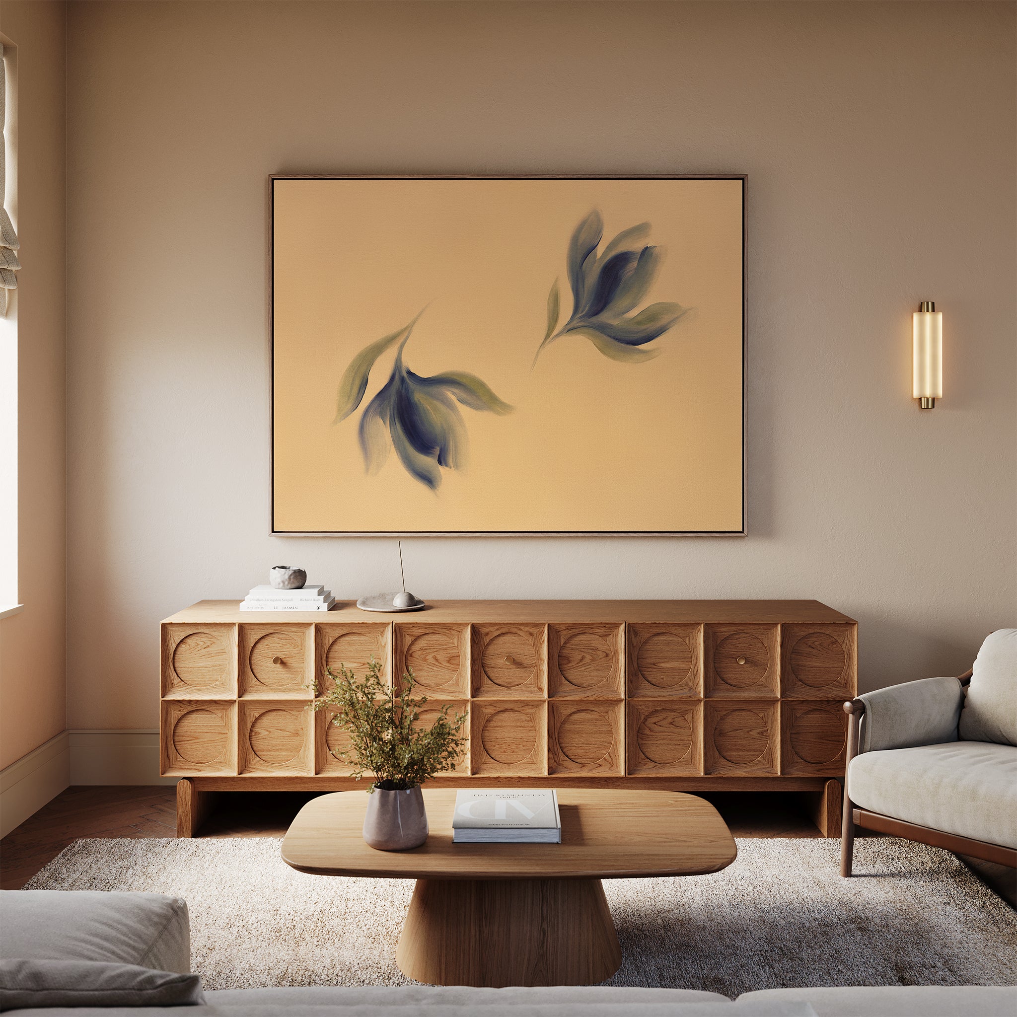 A modern living room features a wooden sideboard, a beige sofa, a wooden coffee table with a book, flowers in a vase on a textured rug, and the Dancing Leaves Canvas Art - Horizontal as vibrant botanical wall decor.