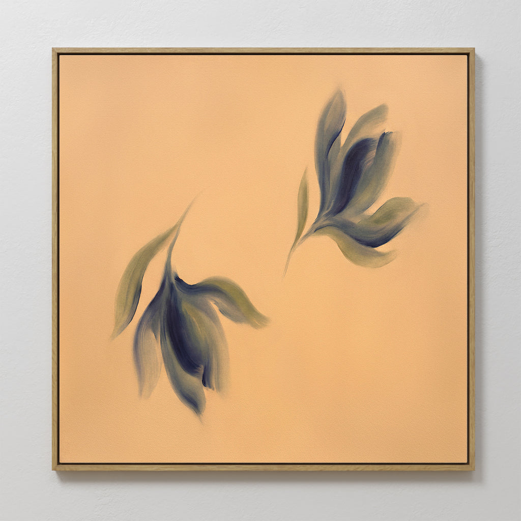 The Dancing Leaves Canvas Art - Square features two abstract, blurred leaf forms in green and blue on a soft peach background with a thin gold frame, making it an ideal Nordic Park-inspired botanical wall art piece.