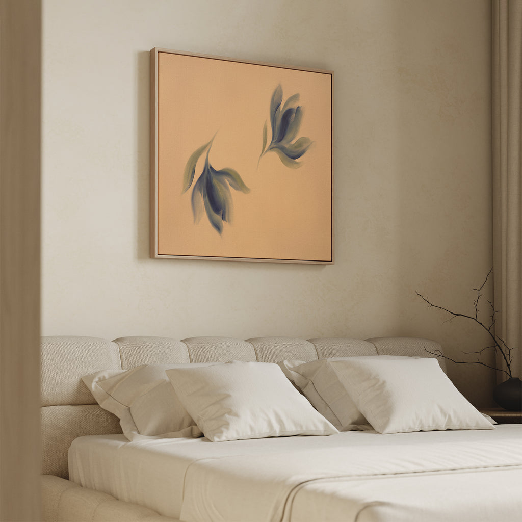 A modern, minimalist bedroom features a beige upholstered bed with white bedding. Above the bed hangs the Dancing Leaves Canvas Art - Square, a botanical print that adds Nordic Park charm and serenity to the space.