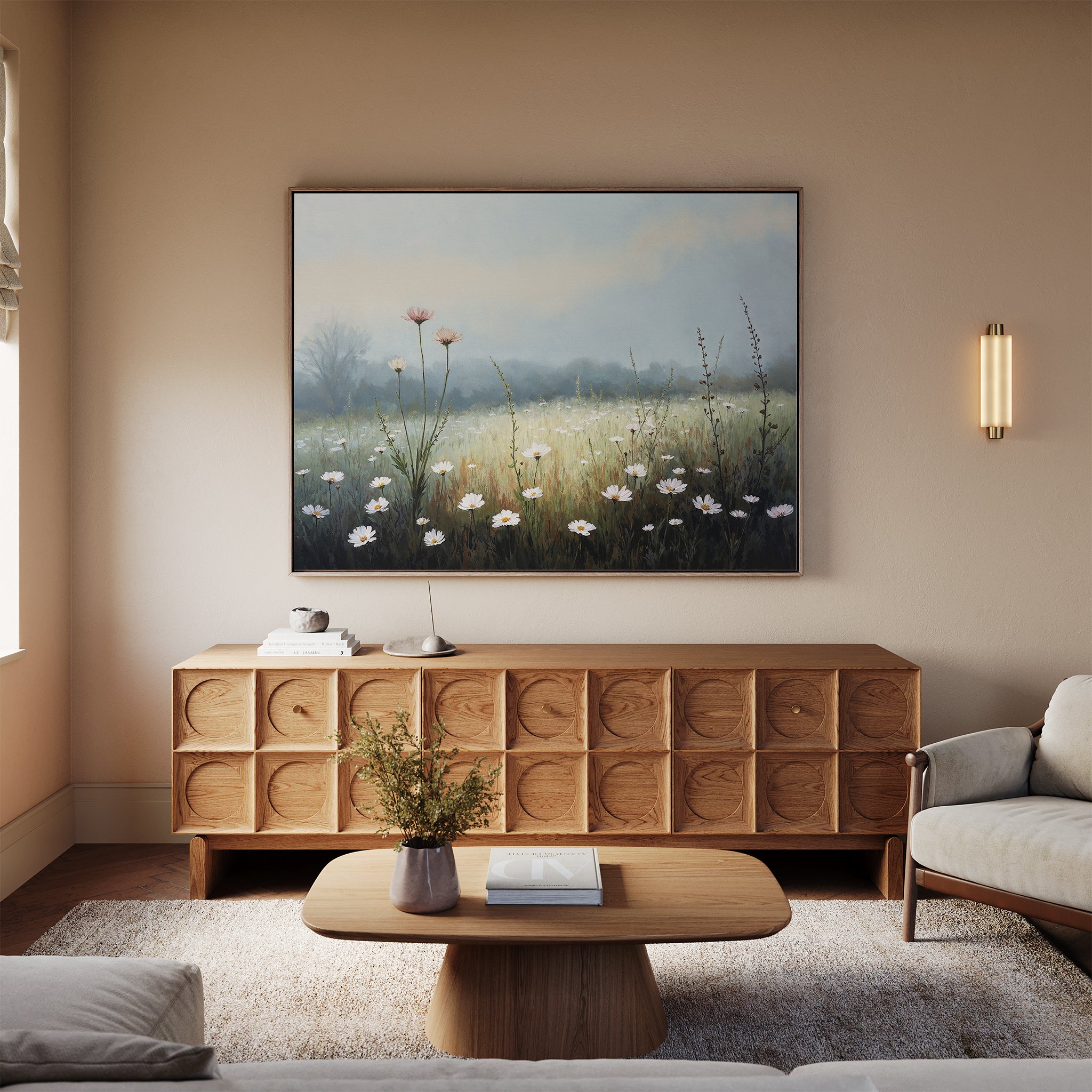 A cozy living room with a wooden sideboard, coffee table, light sofa, and the striking Dawn Meadow Canvas Art - Horizontal. Soft natural light streams in through a window while a small vase of flowers adorns the table.