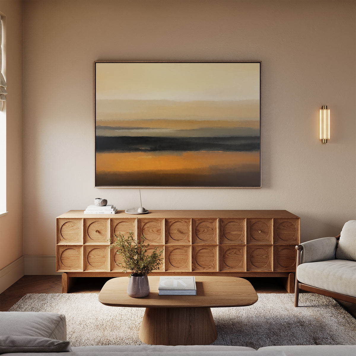 A modern living room featuring a light sofa, wooden coffee table with a vase of flowers, textured wooden sideboard, and the Desert Mirage Canvas Art - Horizontal in warm earth tones displayed on the wall.