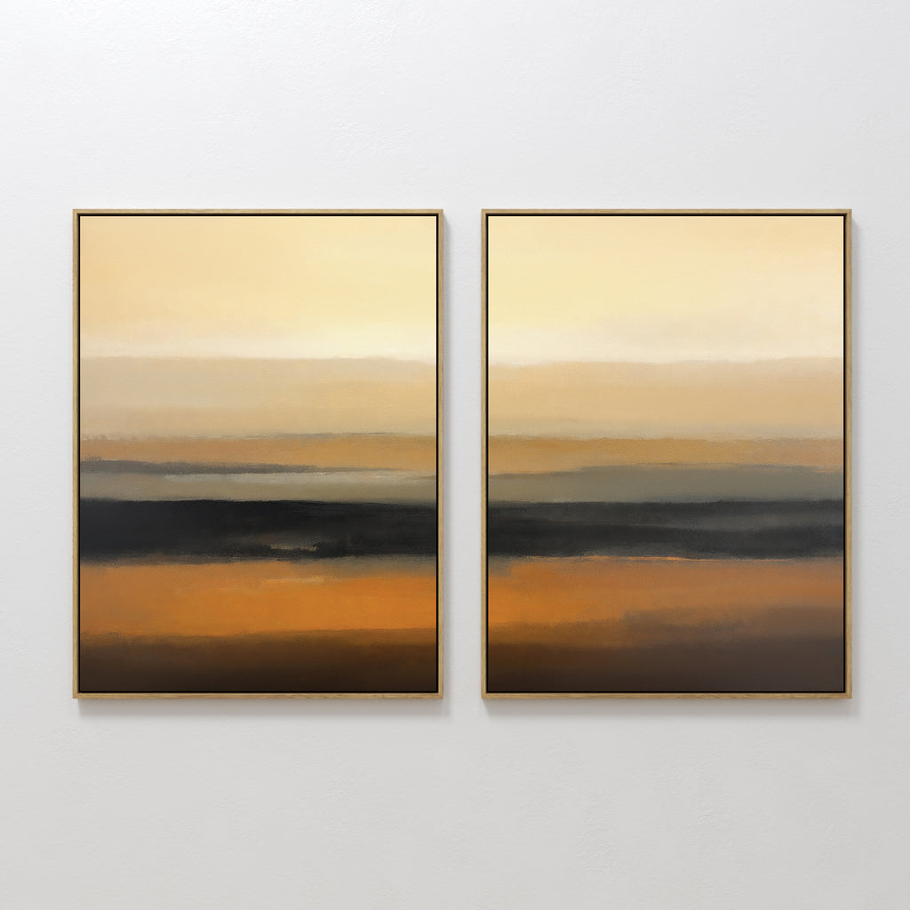 Desert Mirage - Set Of 2 features framed abstract prints with horizontal layers of gold, orange, brown, and black. The earthy tones blend seamlessly to create a serene gradient effect inspired by desert landscapes.