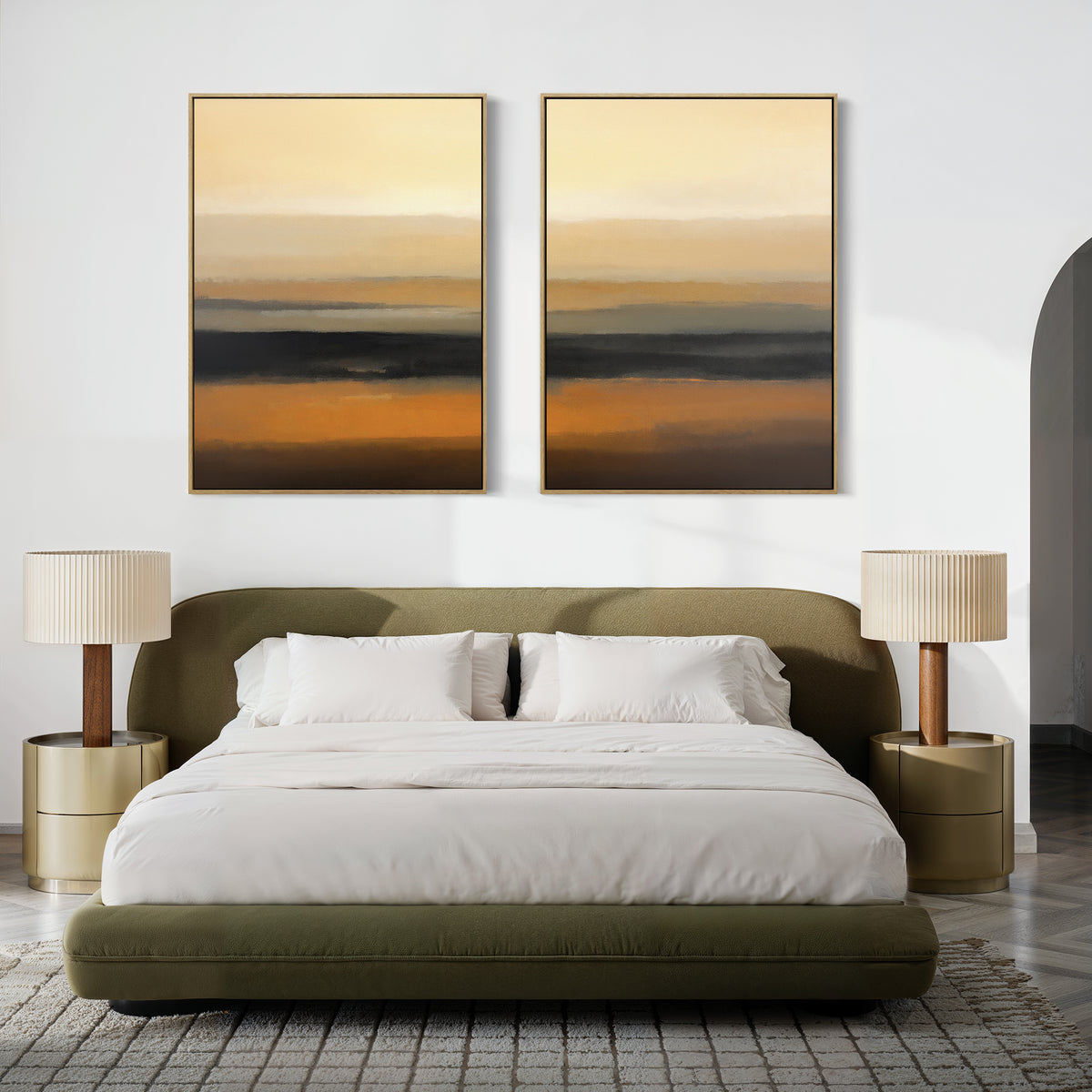 A modern bedroom with an olive green upholstered bed, white bedding, two gold nightstands with matching lamps, and the Desert Mirage - Set Of 2 abstract desert landscape art prints in earth tones above the bed.
