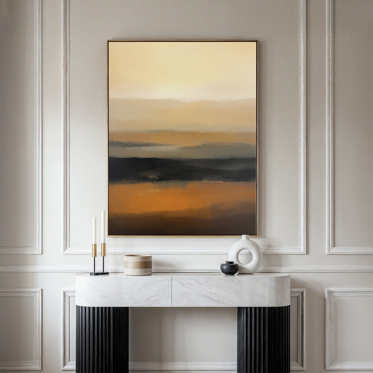 A minimalist console table with decorative objects sits against a white paneled wall. Above it hangs the Desert Mirage Canvas Art - Vertical, featuring earth-toned abstract patterns, creating a calm and modern atmosphere.