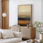 A modern minimal living room with a light wood console, desert earth tones, ceramic vases, books, a beige sofa with cushions, a round floor lamp, a potted plant, and the Desert Mirage Canvas Art - Vertical as an abstract focal point.