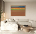 A modern living room with a light beige sectional, low wood coffee table, tall plant, floor-to-ceiling curtains, and the Desert Plains Canvas Art - Horizontal brings southwestern warmth to the space.