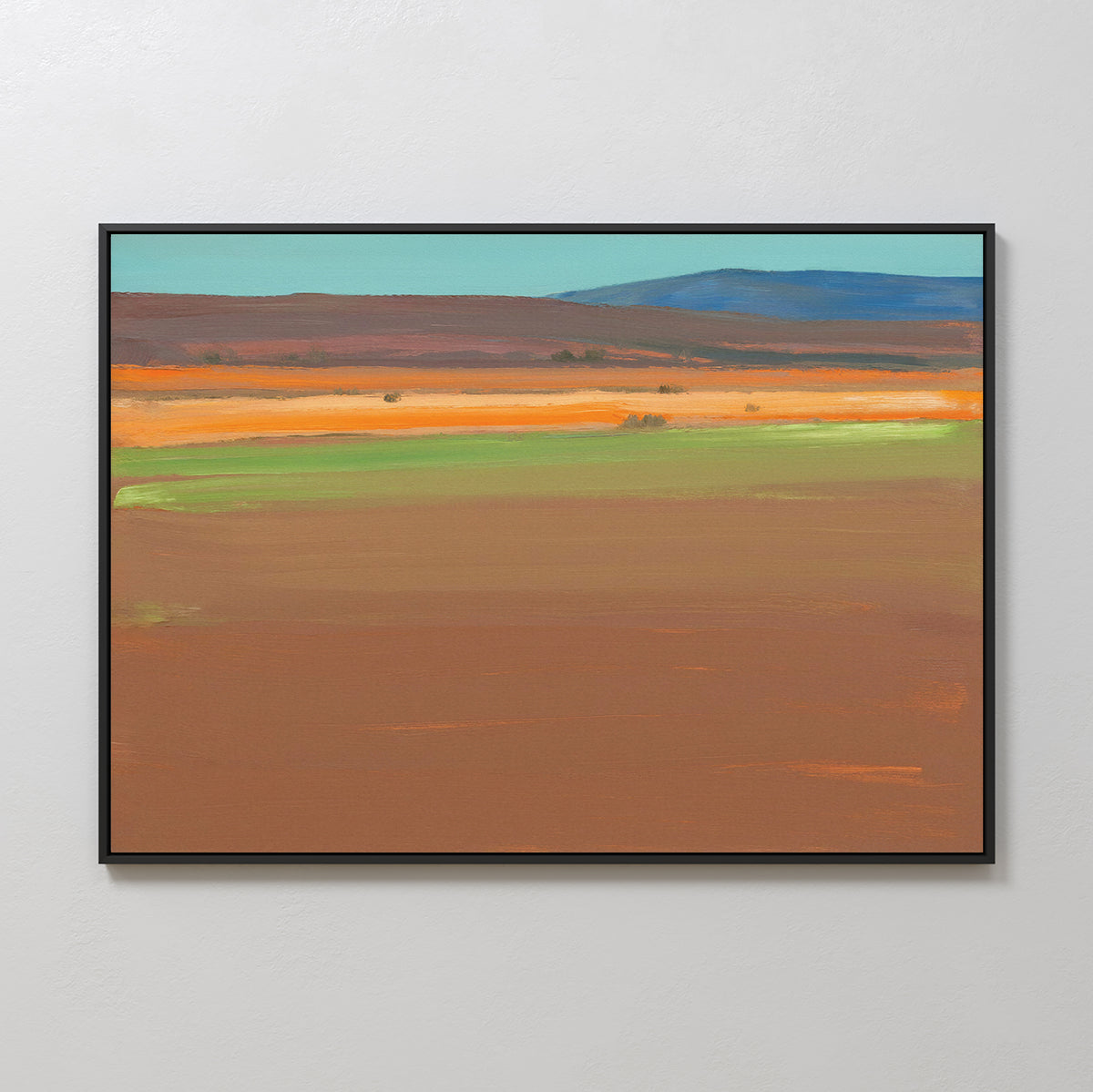 The "Desert Plains Canvas Art - Horizontal" is a framed print with broad brown, green, orange, and blue bands creating an abstract southwestern landscape beneath a pale sky, displayed on a white wall.