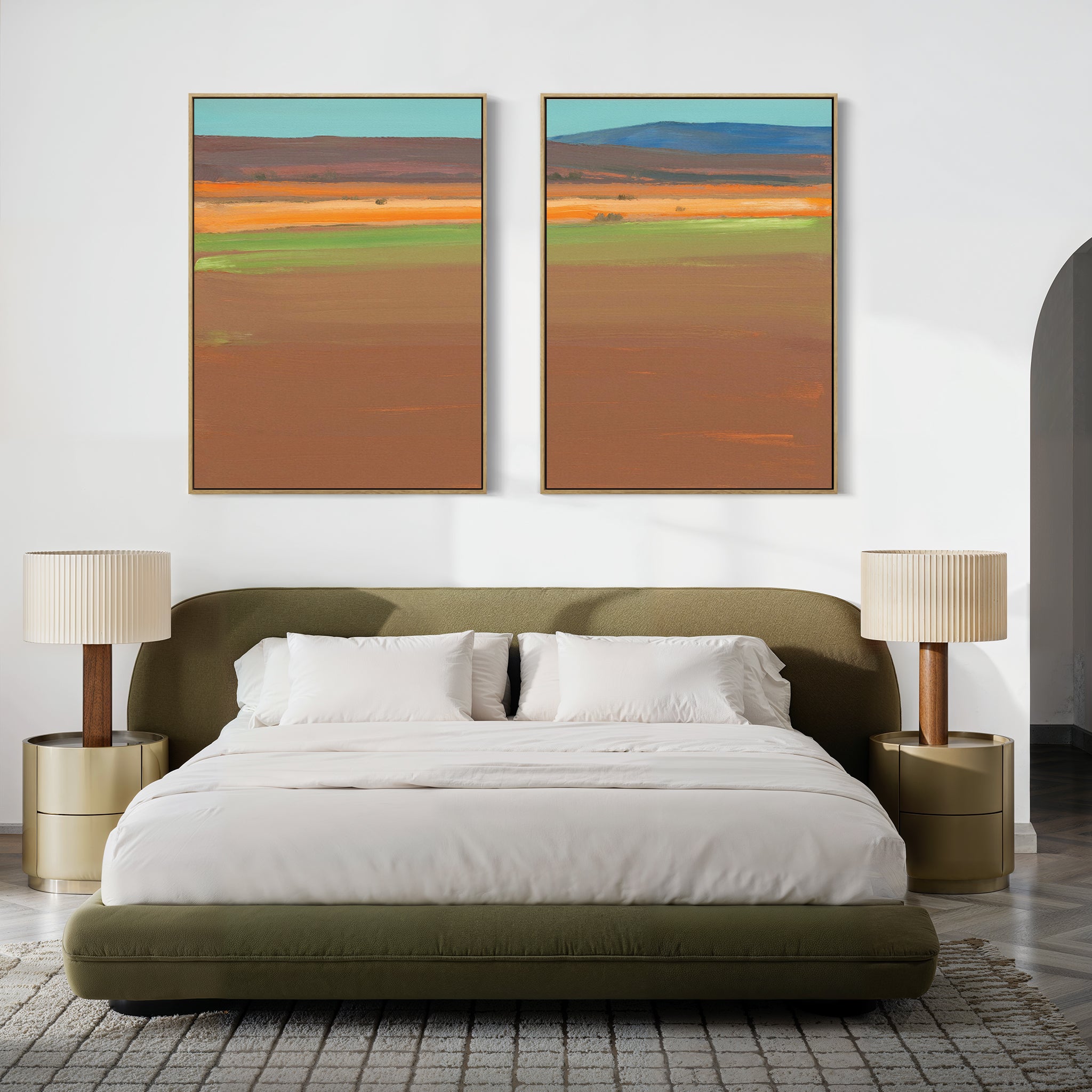 A modern bedroom with a low green bed, white bedding, round beige nightstands, matching lamps, and the "Desert Plains - Set of 2" colorful desert landscape canvas prints above the headboard.