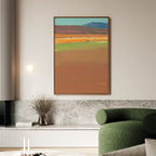 A modern living room features a green curved sofa, marble bench with a vase of dried flowers, and Desert Plains Canvas Art - Vertical—a large abstract landscape in warm earthy tones—hung above for striking modern decor.