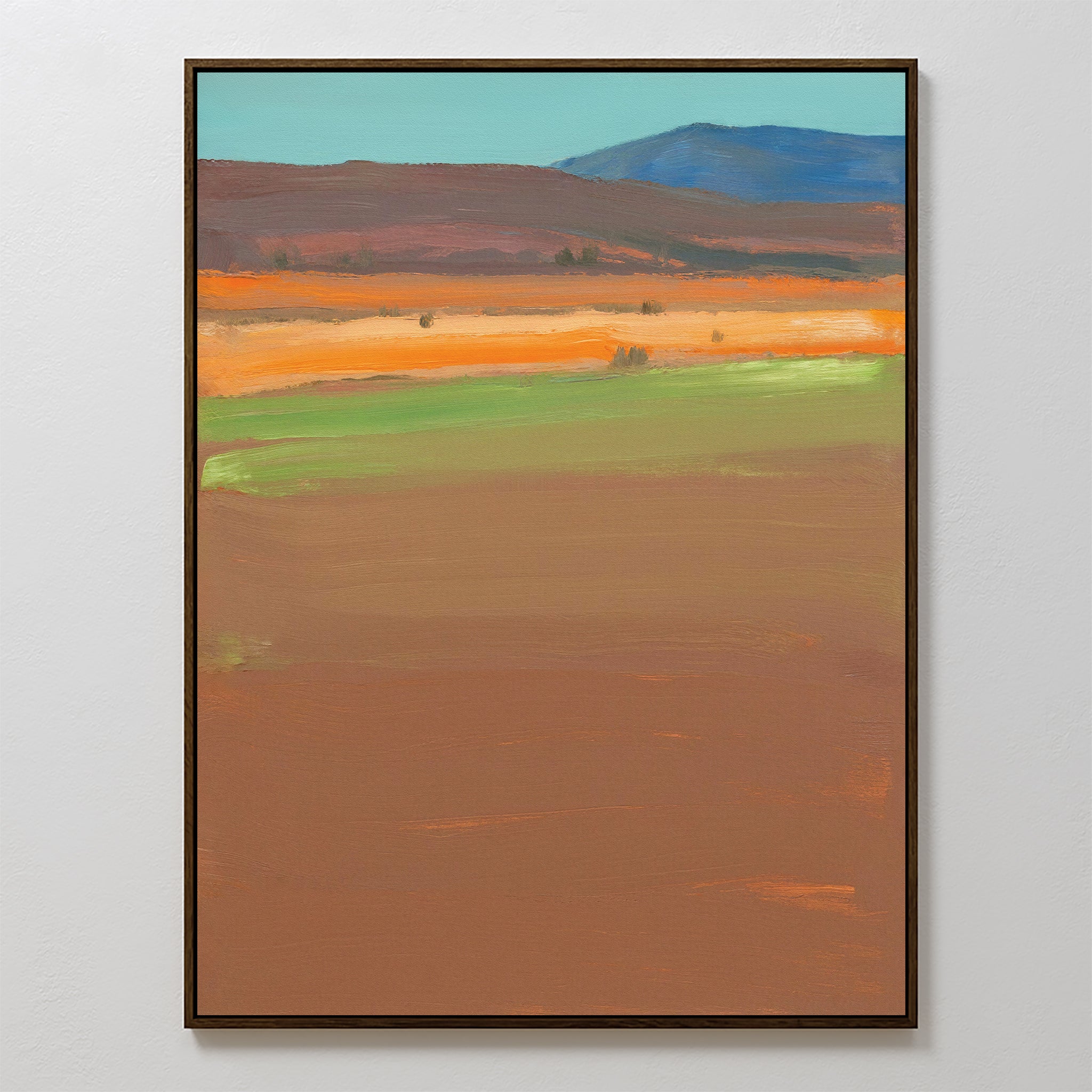 Desert Plains Canvas Art - Vertical features abstract bands of earthy brown, green, orange, and blue. This southwestern-inspired wall art comes beautifully framed and is shown on a light-colored wall for a modern touch.