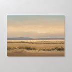 Desert Solitude Canvas Art - Horizontal features a serene desert landscape with dry shrubs, sandy ground, and distant blue mountains under a hazy sky—ideal wall decor or canvas print for southwestern art lovers.