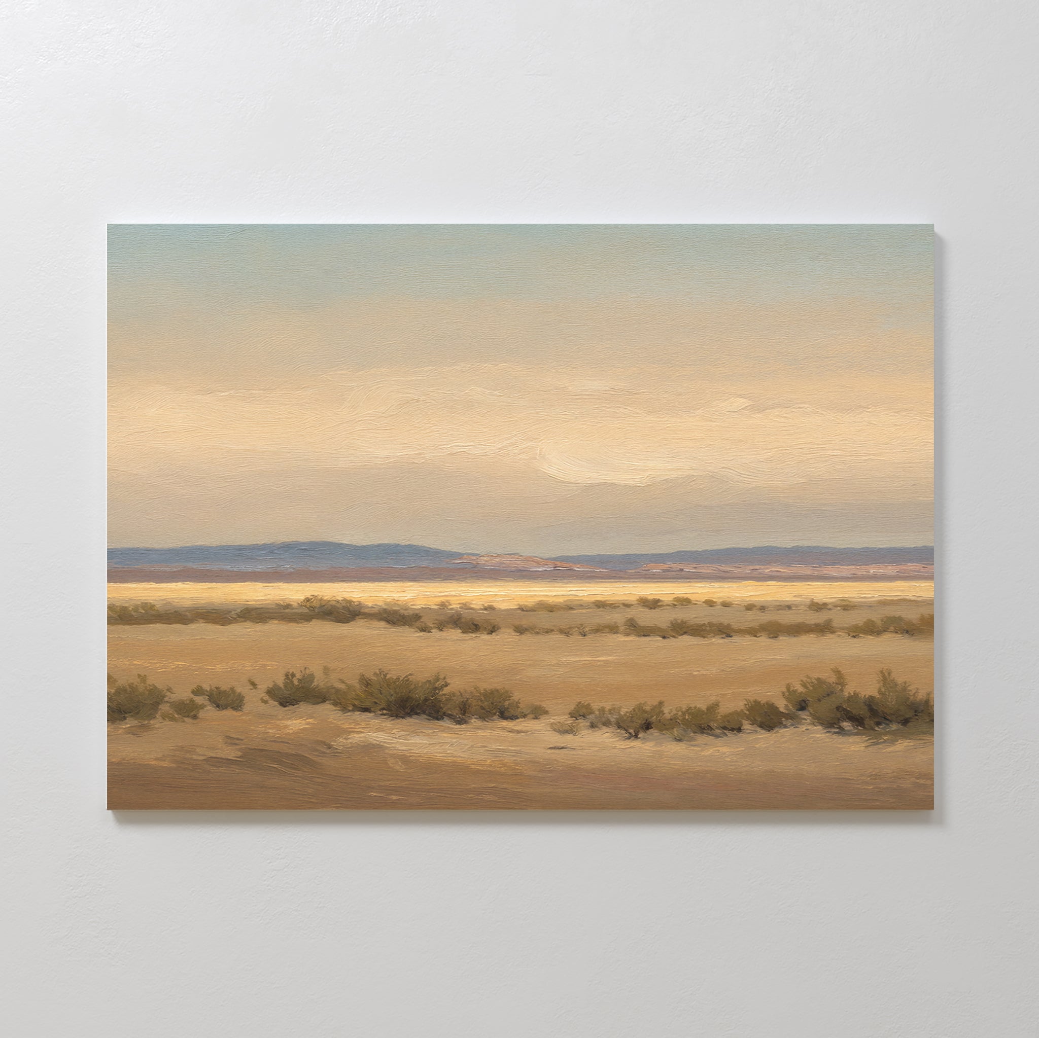 Desert Solitude Canvas Art - Horizontal features a serene desert landscape with dry shrubs, sandy ground, and distant blue mountains under a hazy sky—ideal wall decor or canvas print for southwestern art lovers.
