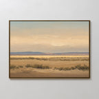 Desert Solitude Canvas Art - Horizontal: A framed canvas print featuring a serene desert landscape with dry shrubs, open plains, blue mountains, and a cloudy sky—perfect wall decor inspired by southwestern landscape art.