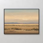 Desert Solitude Canvas Art - Horizontal features a serene desert landscape with sandy ground, sparse bushes, and distant mountains beneath a hazy sky—perfect for adding tranquil decor to any white wall.